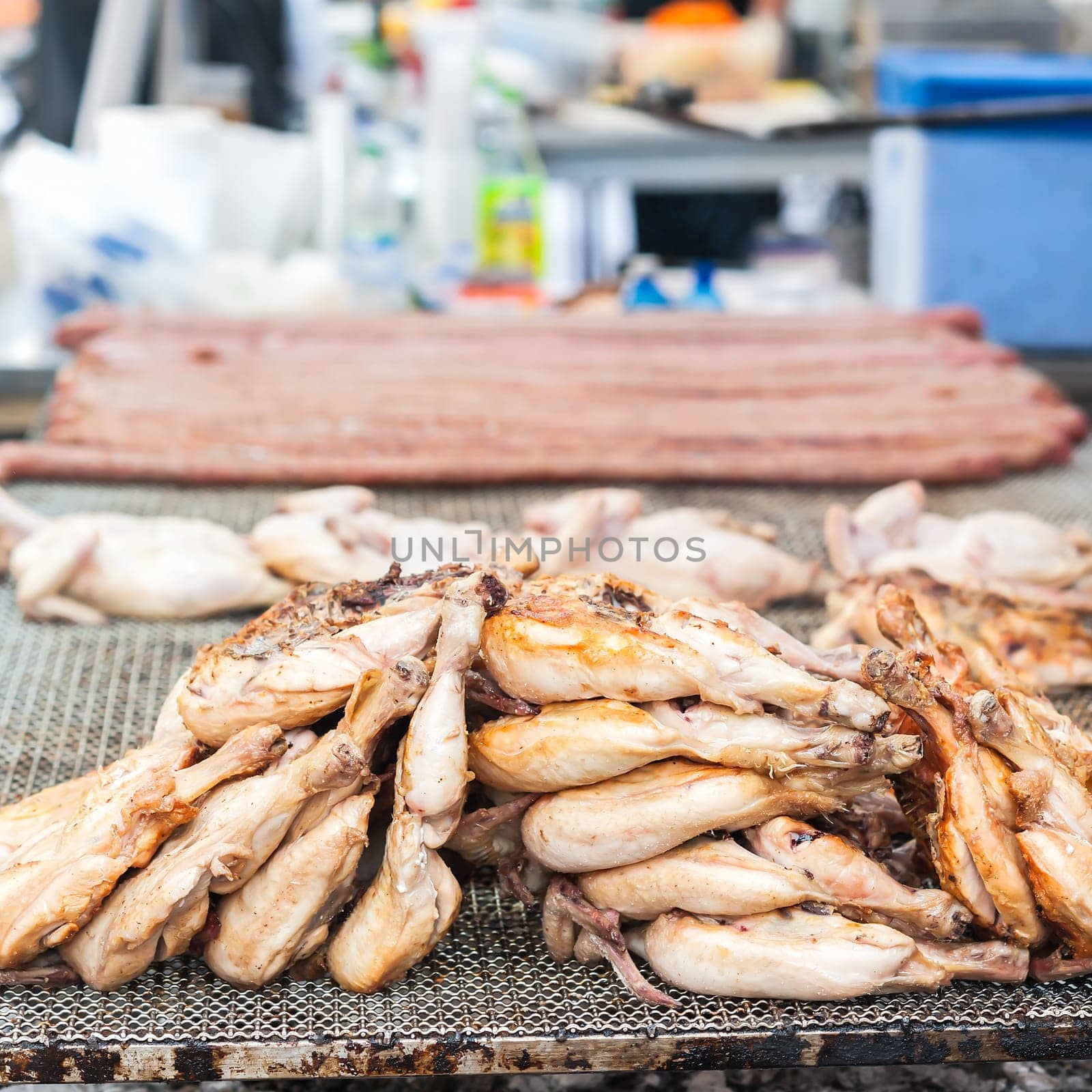 Chicken thighs cooked on the grill. During a village feast.