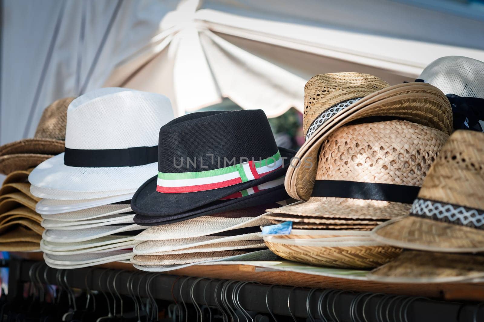 Open market stall with  summer hats for men on sale. Photo in vintage style.