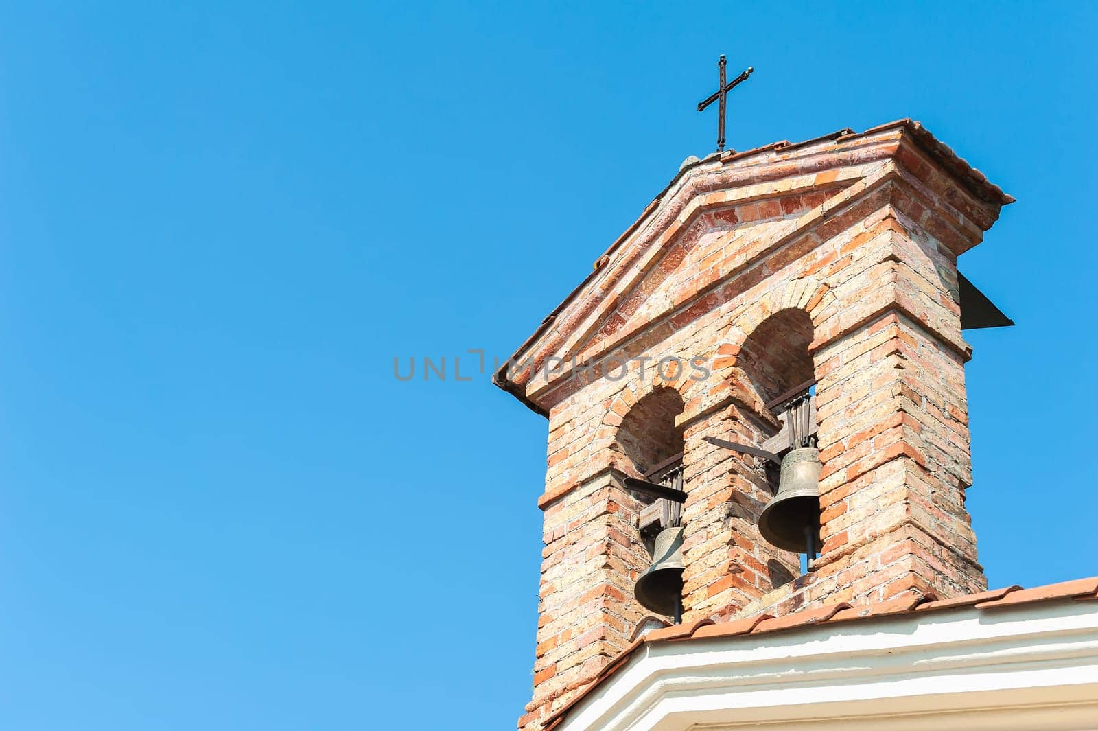 Small bell tower with a bell of a country church in the 14th century