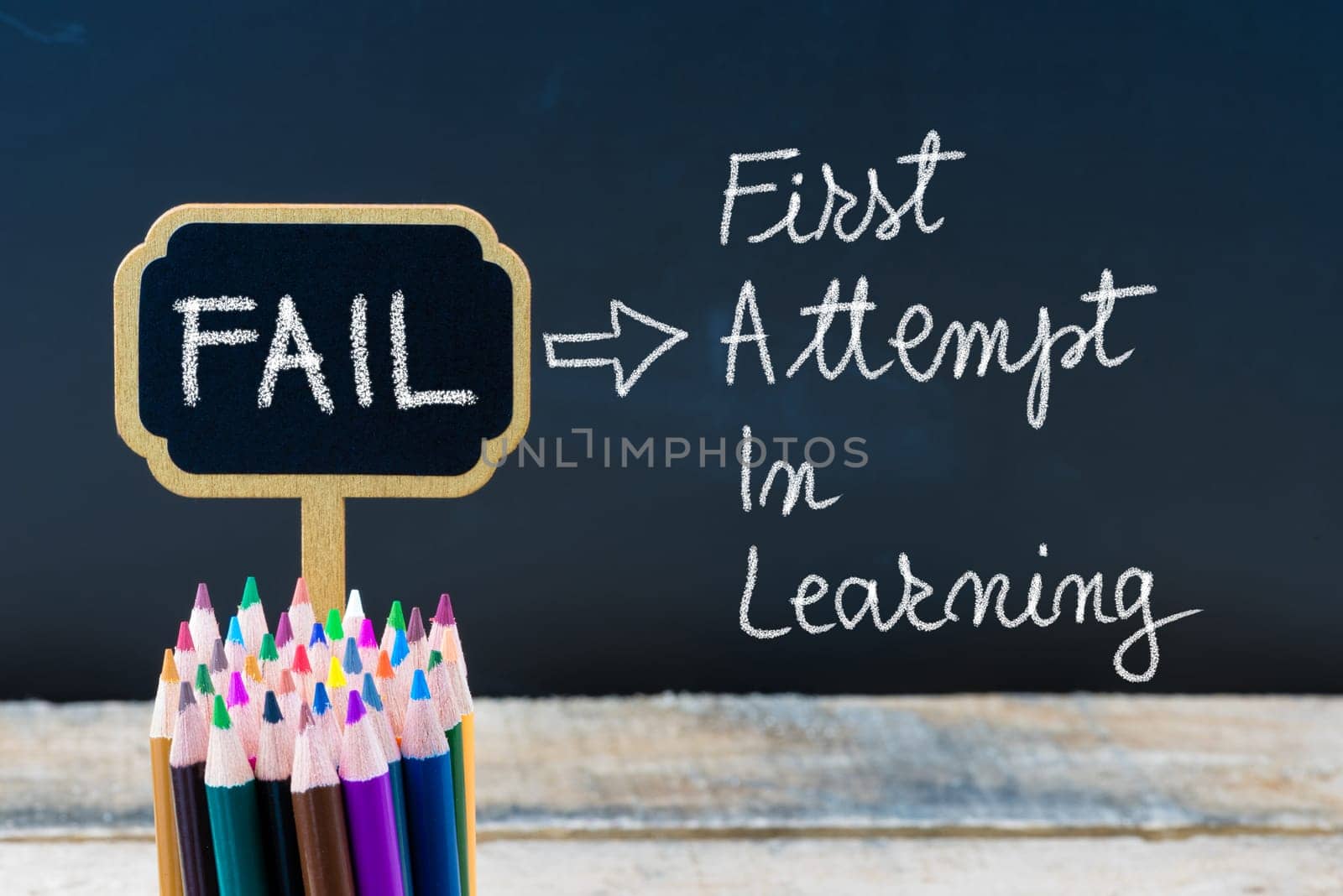 Business Acronym FAIL First Attempt In Learning written with chalk on wooden mini blackboard labels and chalkboard background.