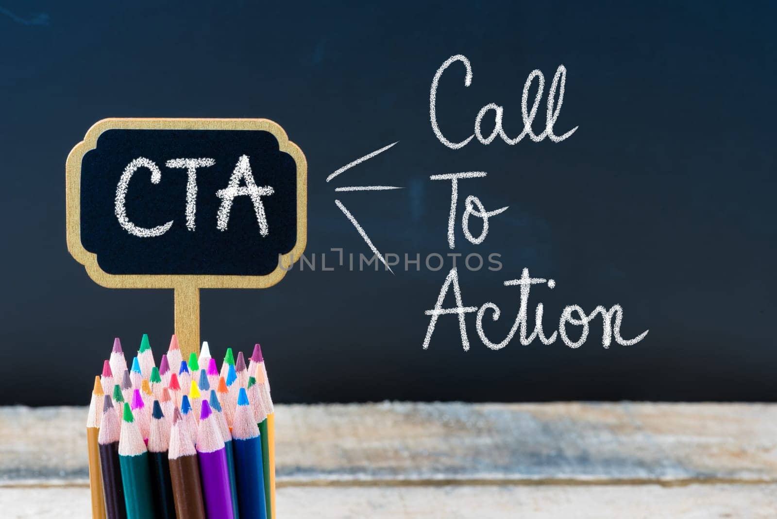 Business Acronym CTA Call To Action written with chalk on wooden mini blackboard labels and chalkboard background.