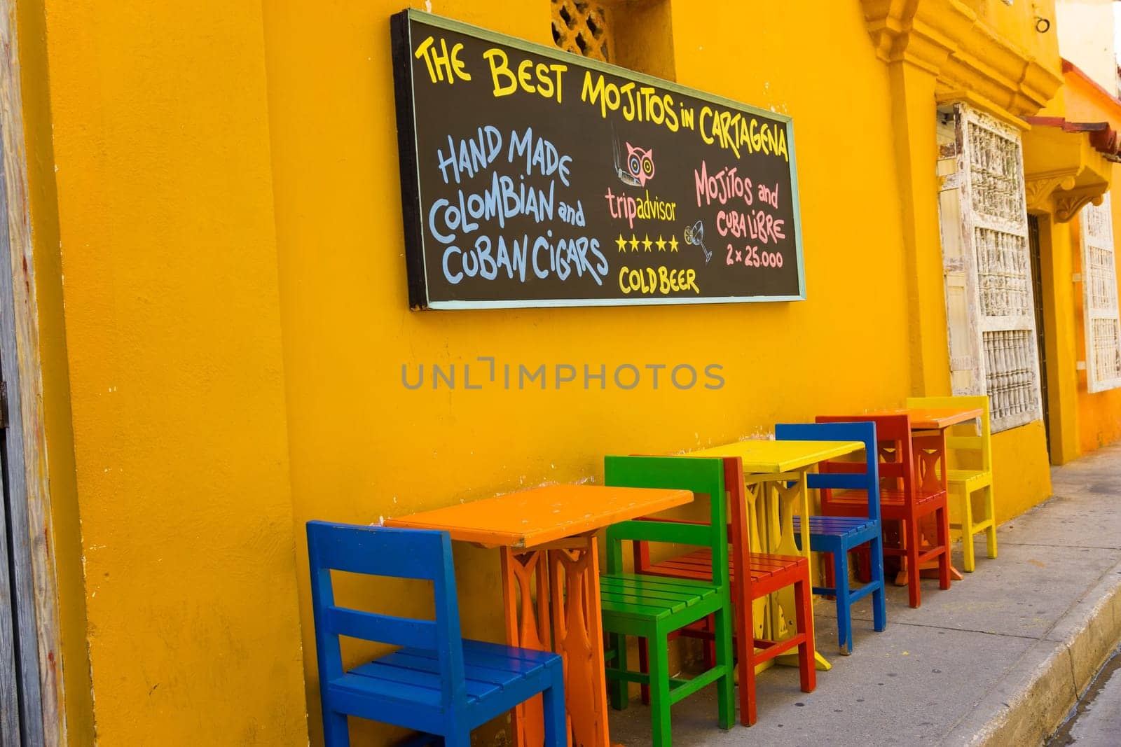 CARTAGENA, COLOMBIA - MAY 23: Colorful chairs and sign of a restaurant in Cartagena, Colombia on May 23, 2016