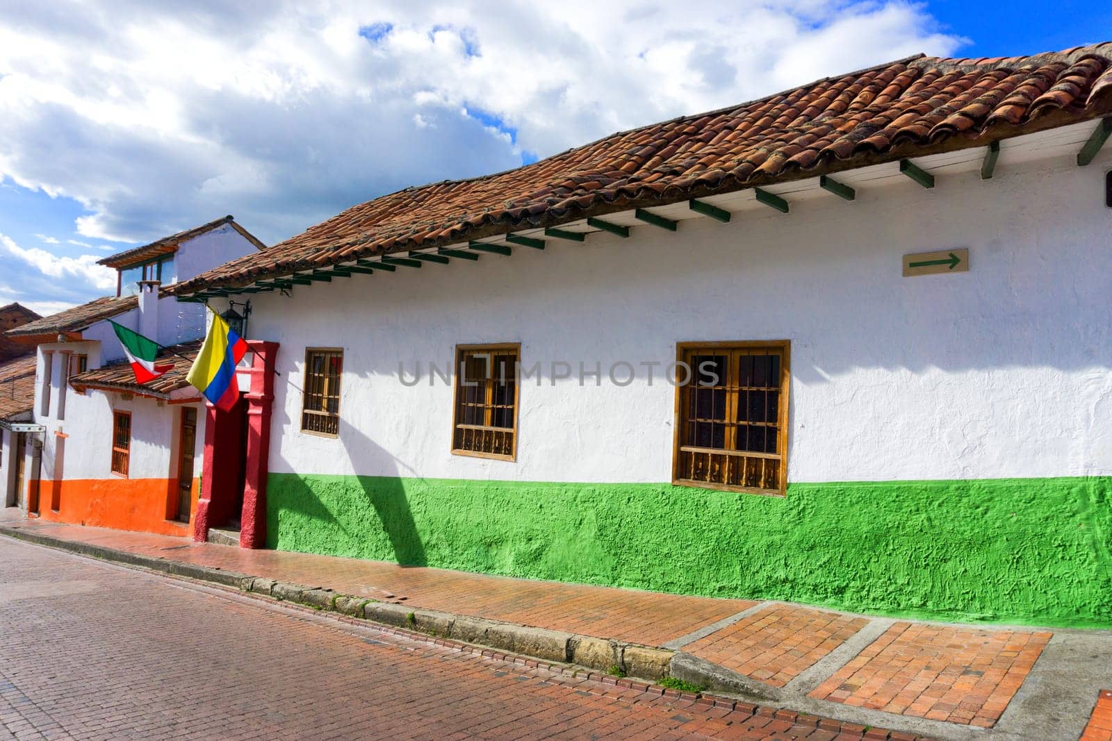 Colonial street with Colombian and Mexican flags in La Candelaria neighborhood in Bogota, Colombia