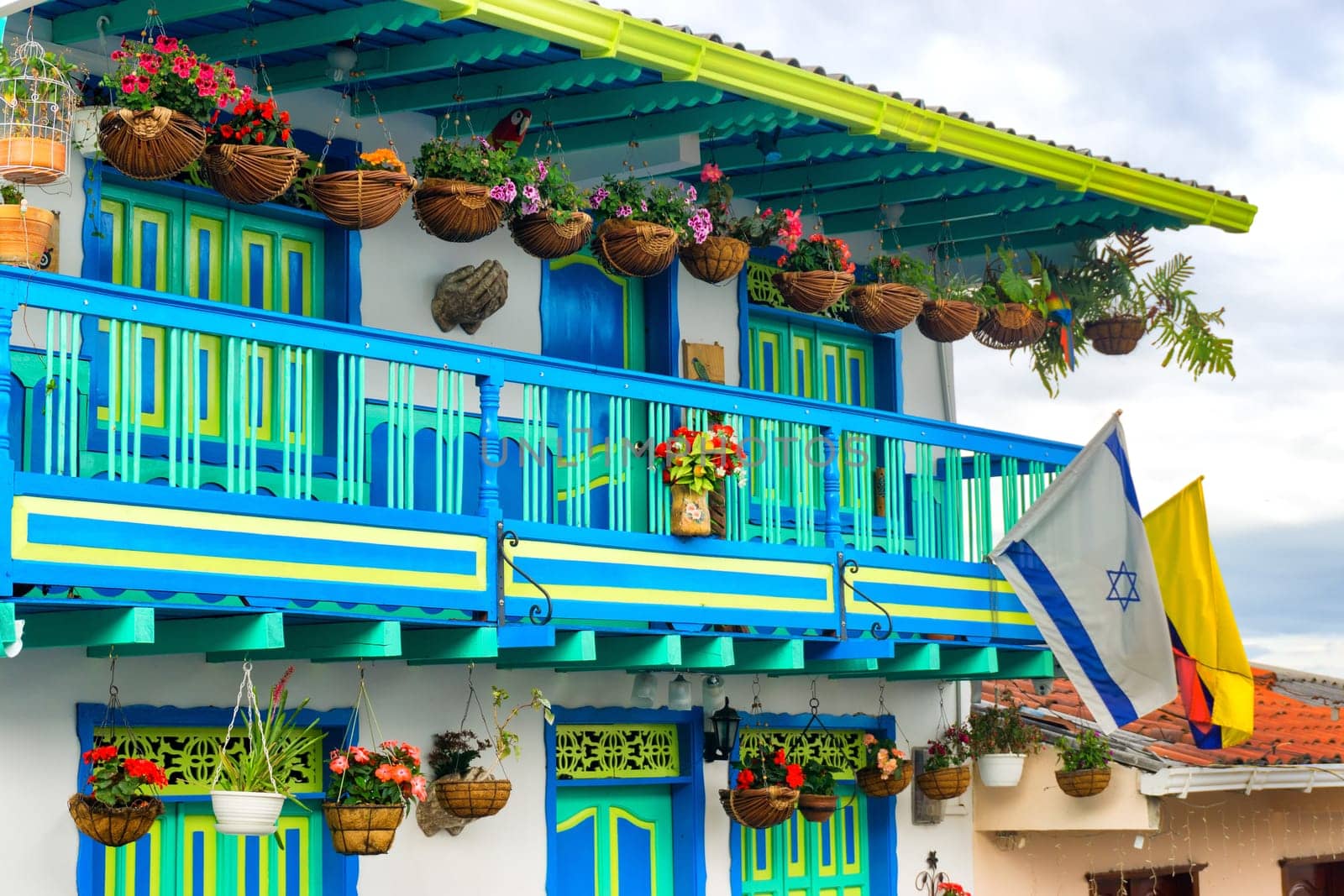 Colorful architecture and flowers with Colombian and Israeli flags in Salento, Colombia