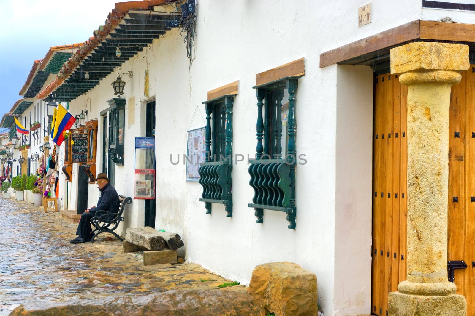 VILLA DE LEYVA, COLOMBIA - APRIL 27: Old man sitting on a bench in the colonial town of Villa de Leyva, Colombia on April 27, 2016