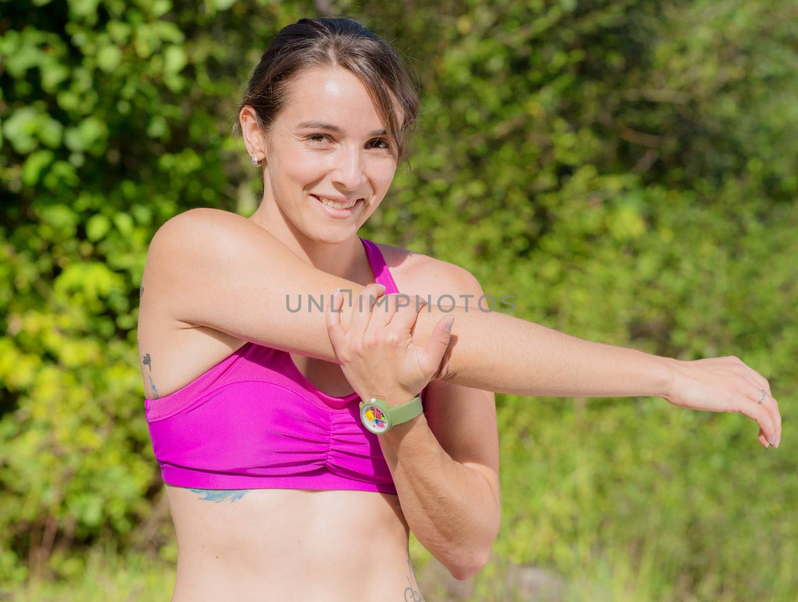 beautiful young fitness woman doing exercise in countryside