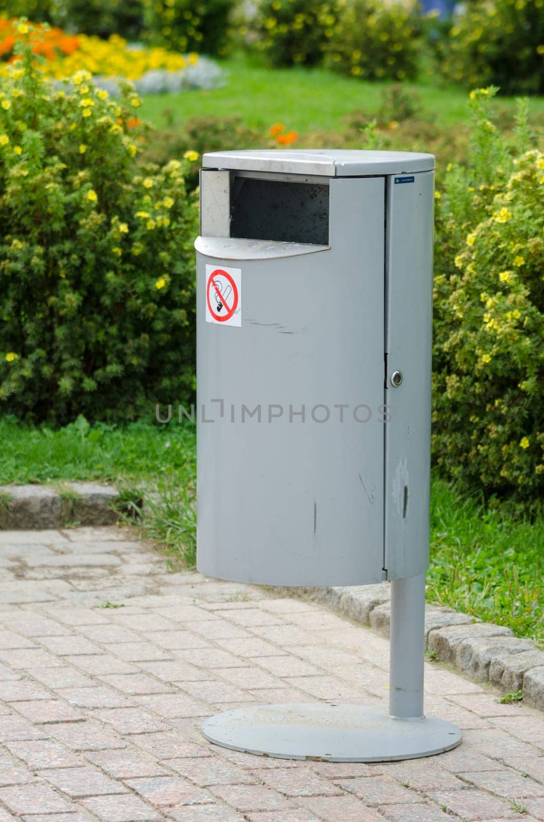 Neat metal urn on a background of manicured lawns