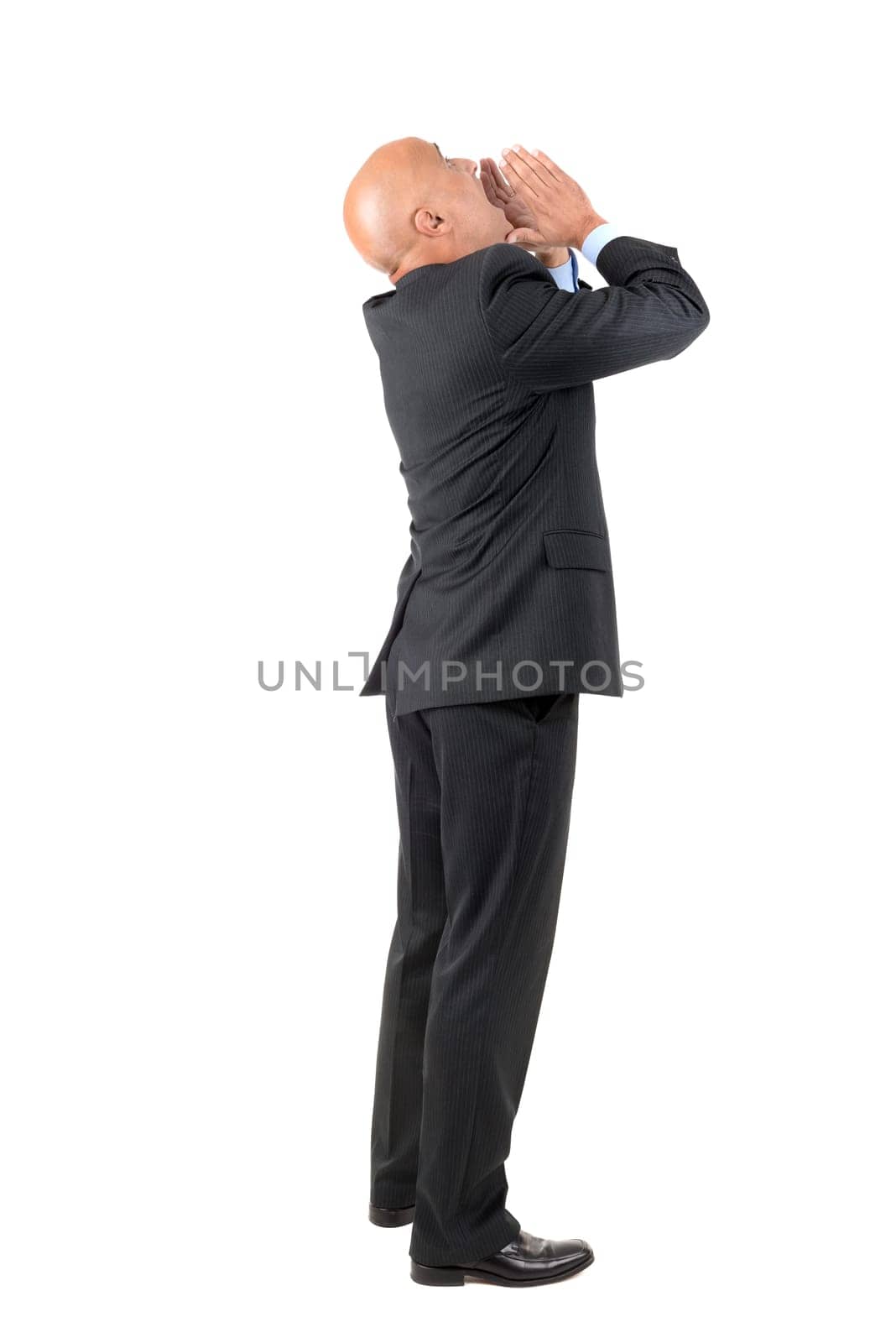 Businessman shouting isolated against a white background
