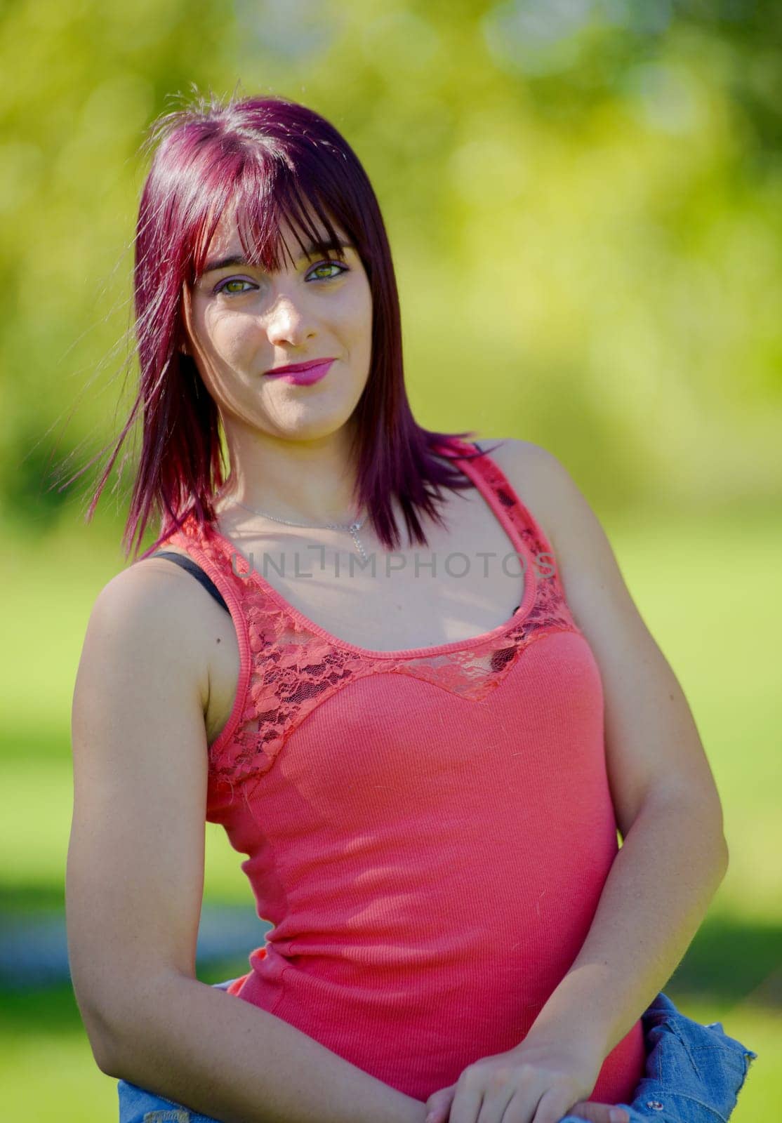 portrait of a young woman with green eyes and red hairs, outdoors