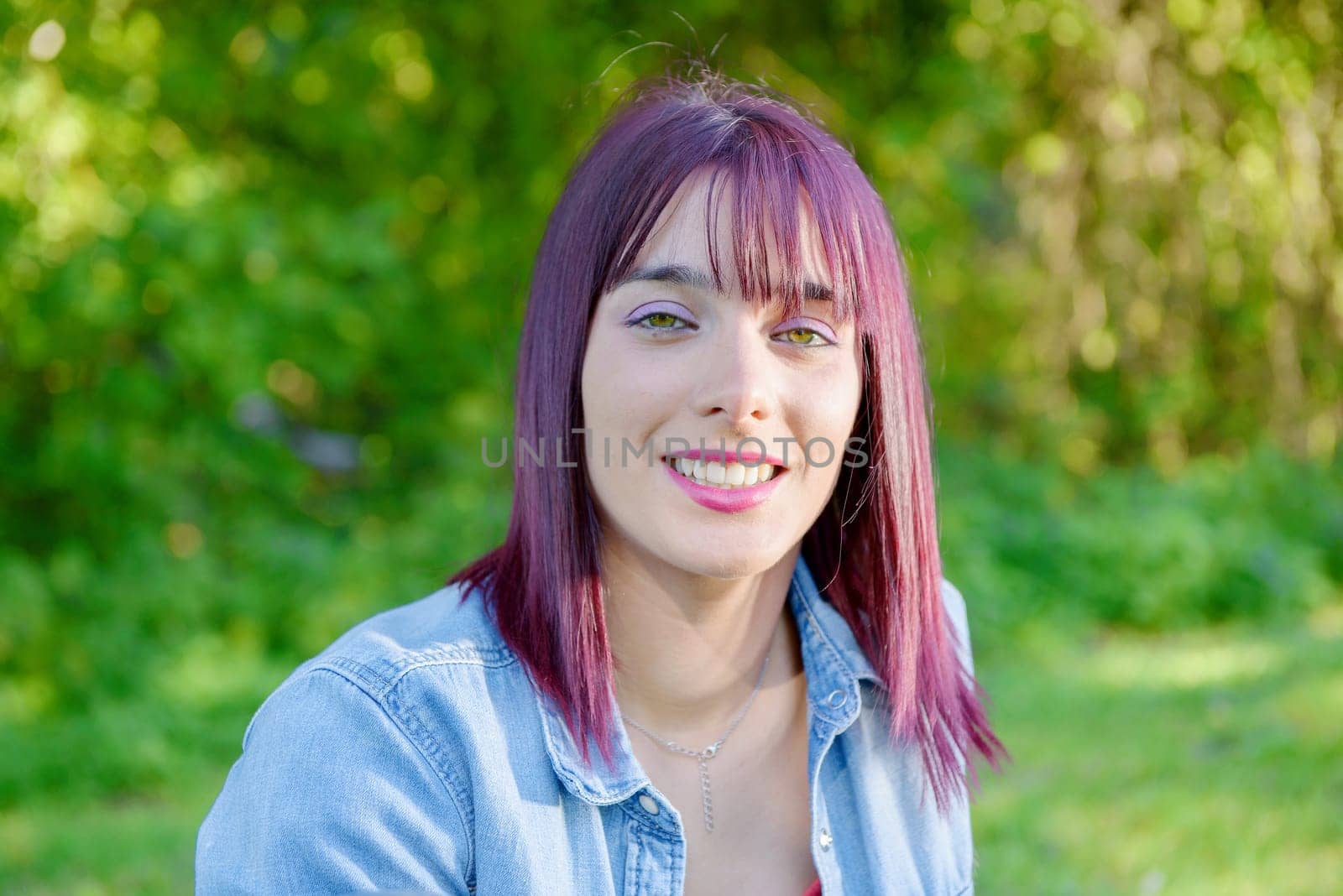 portrait of a young woman with green eyes and red hairs, outdoors