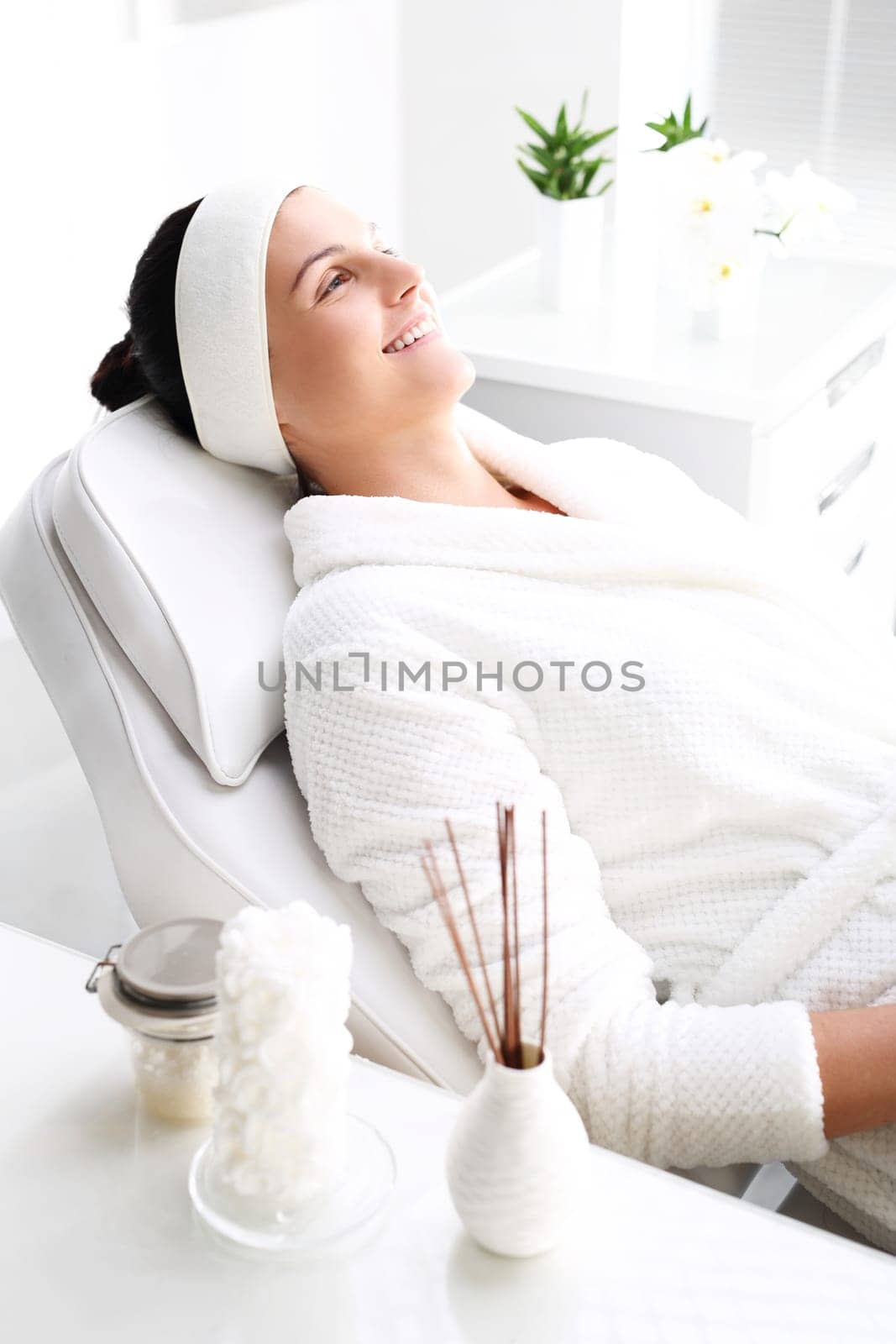 woman in a beauty salon.\nwoman at the spa.\na woman relaxing in a beauty salon.\n