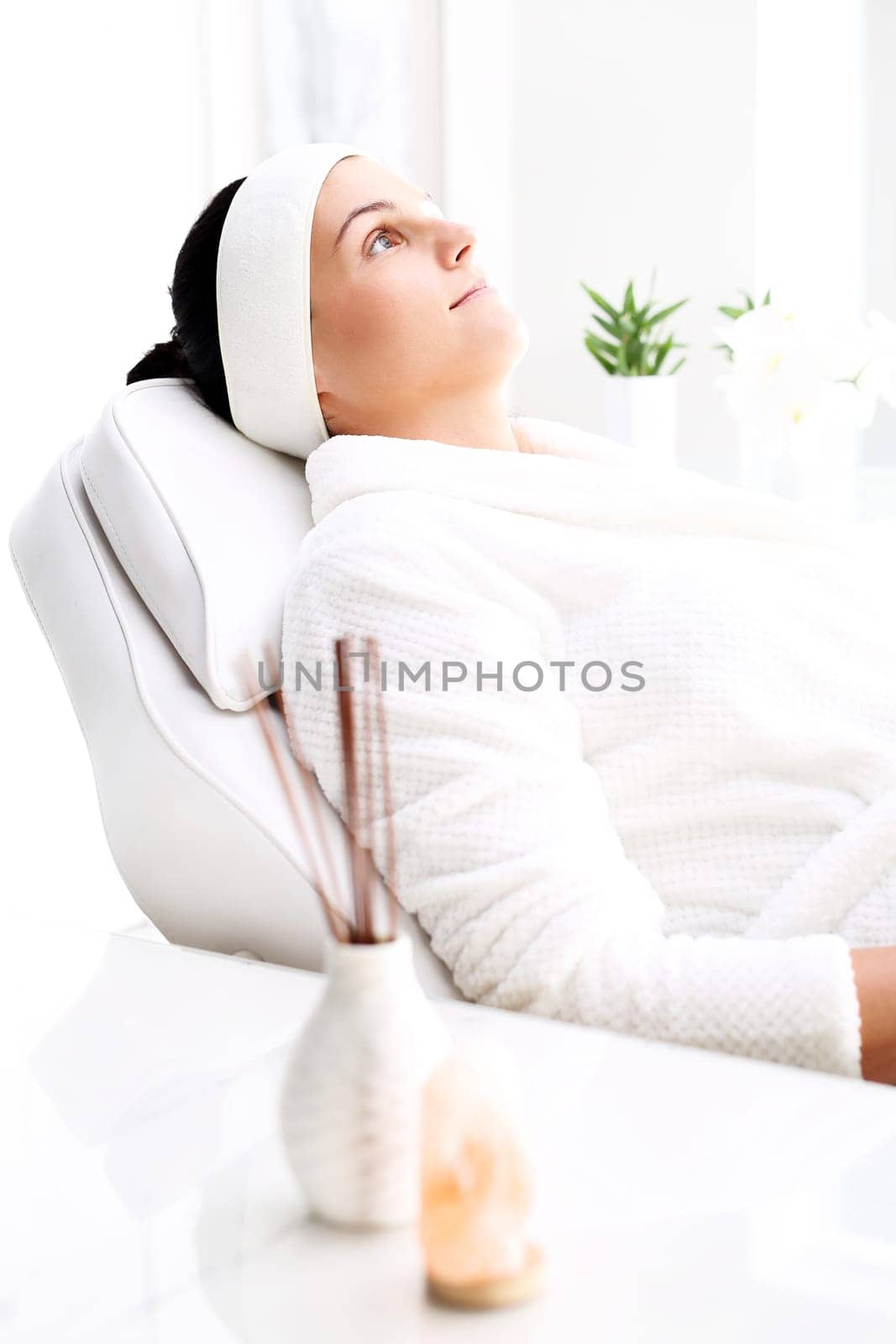 woman in a beauty salon.\nwoman at the spa.\na woman relaxing in a beauty salon.\n