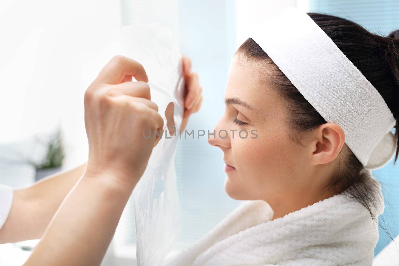 a woman's face during a treatment at a beauty salon\n