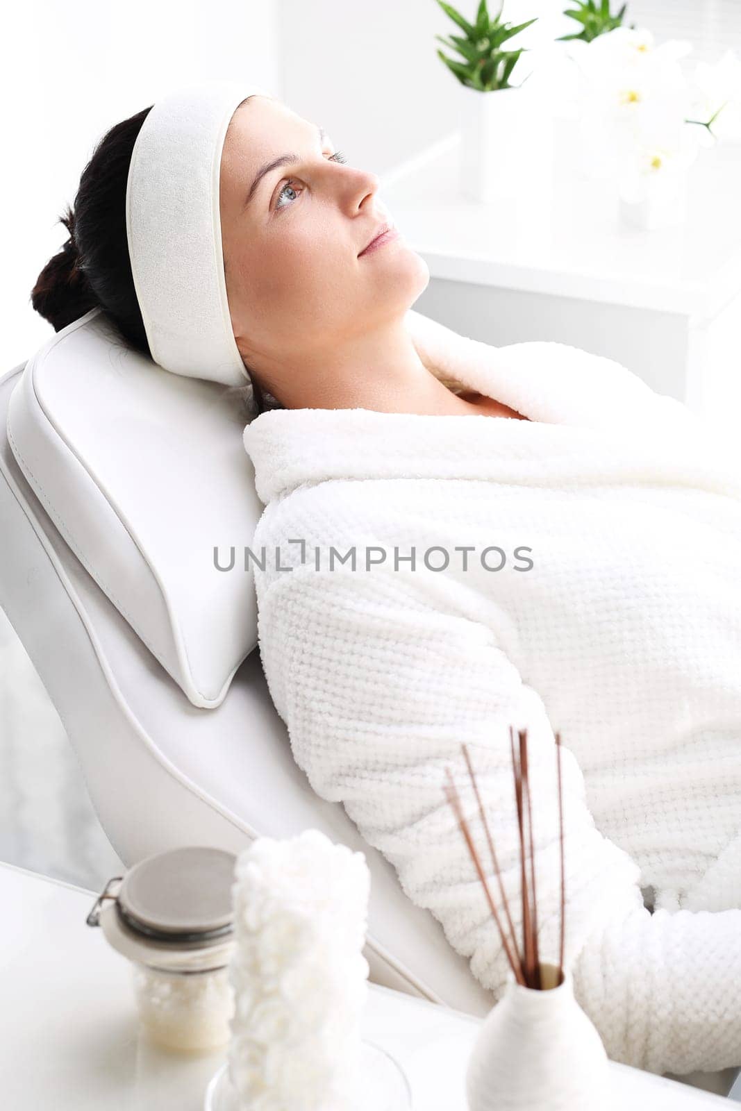 woman in a beauty salon.\nwoman at the spa.\na woman relaxing in a beauty salon.\n