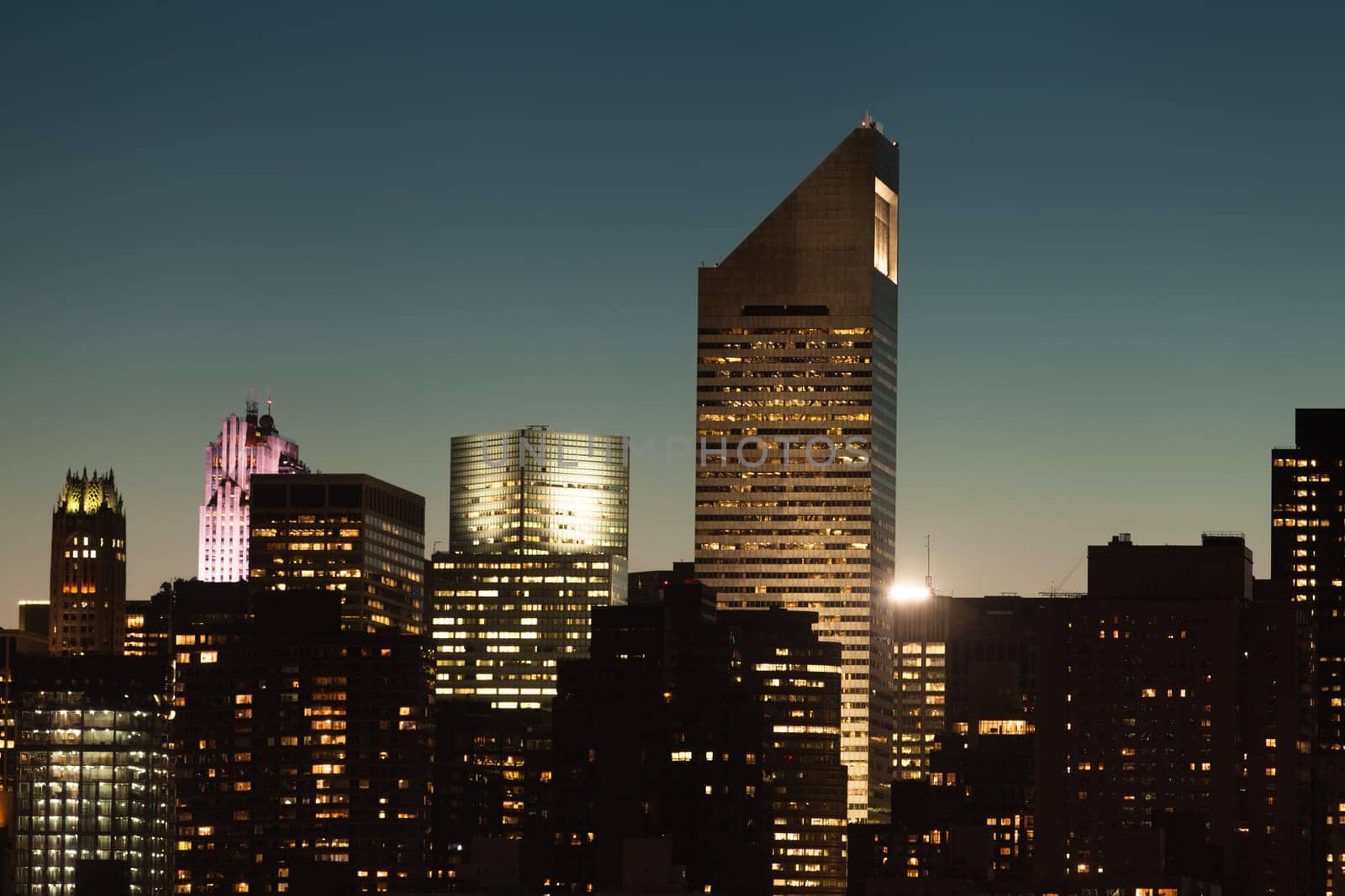 Manhattan cityscape detail with modern skyscrapers and business buildings during twilight in New York City, USA.