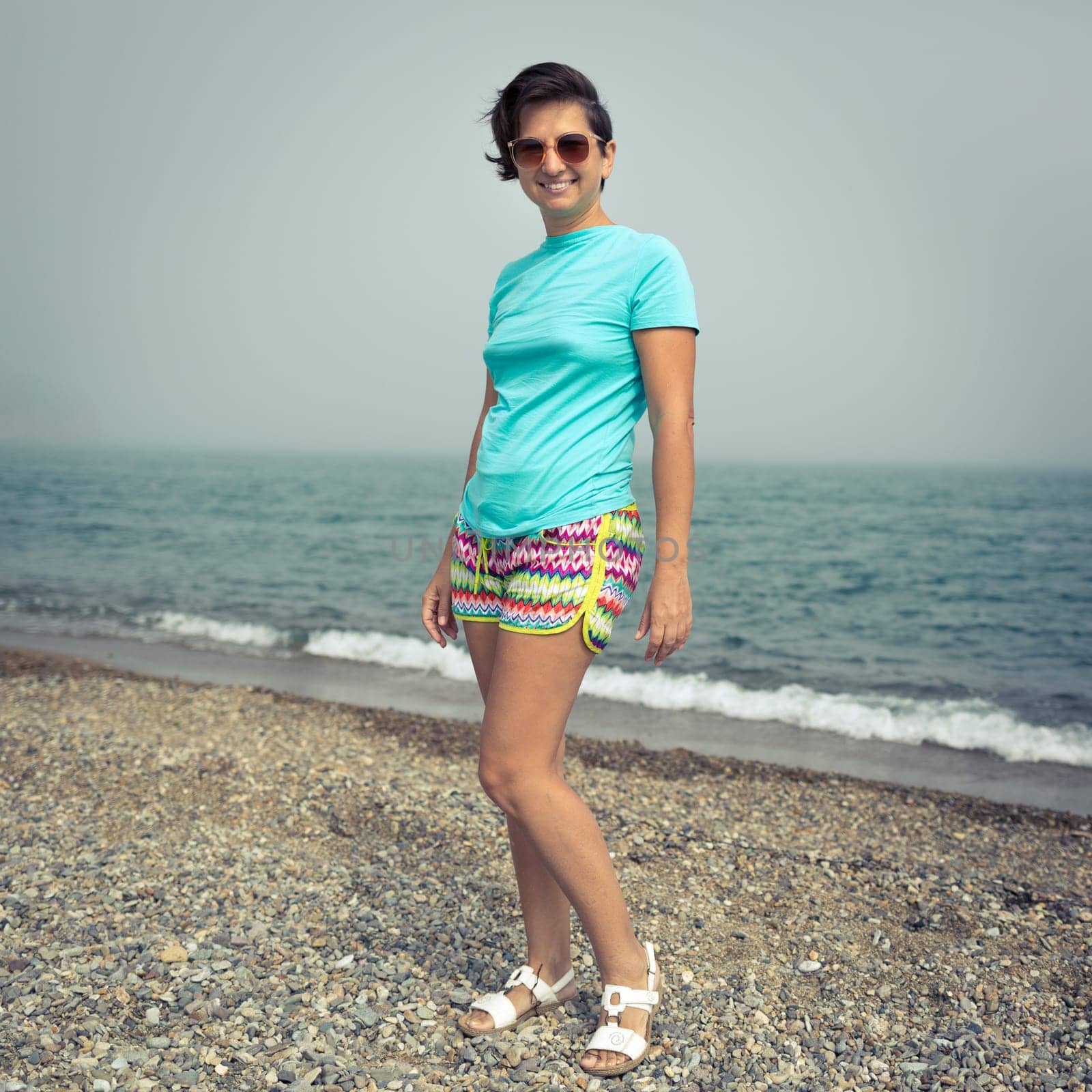 Woman near the sea. Foggy weather
