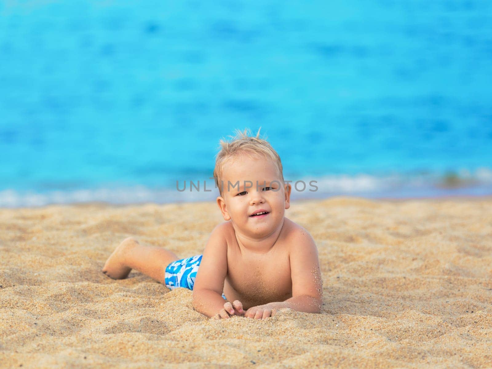 Cute boy relaxing on the tropical beach