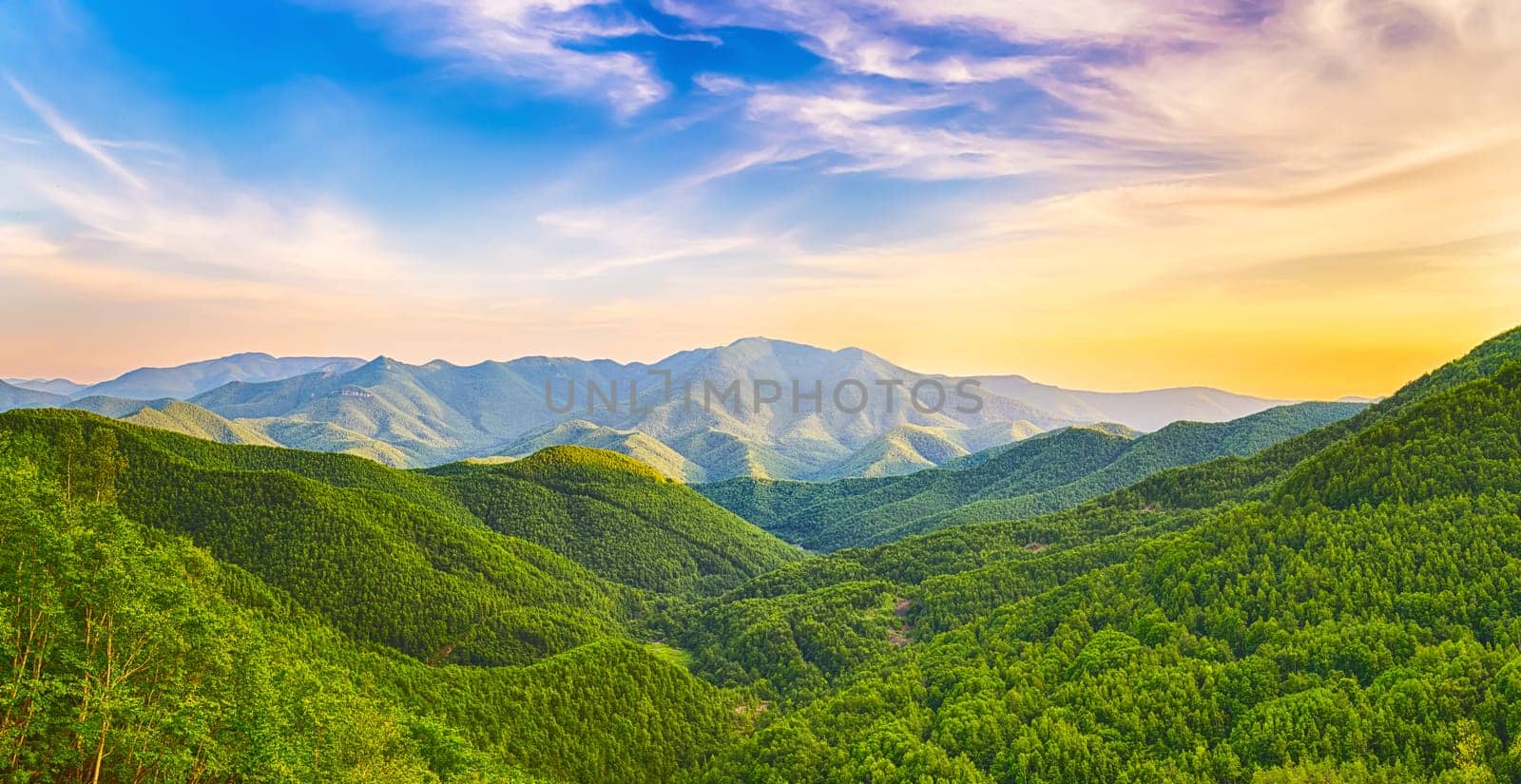 Panoramic view of a mountain valley at sunset time. Panorama