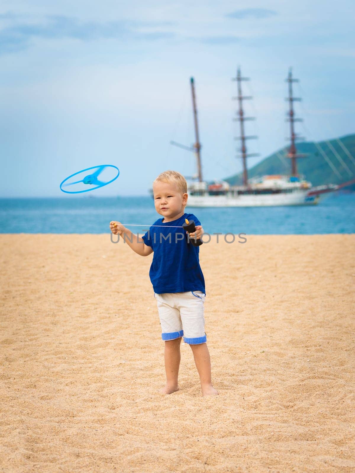 Boy with flying saucer outdoor. Leisure activity