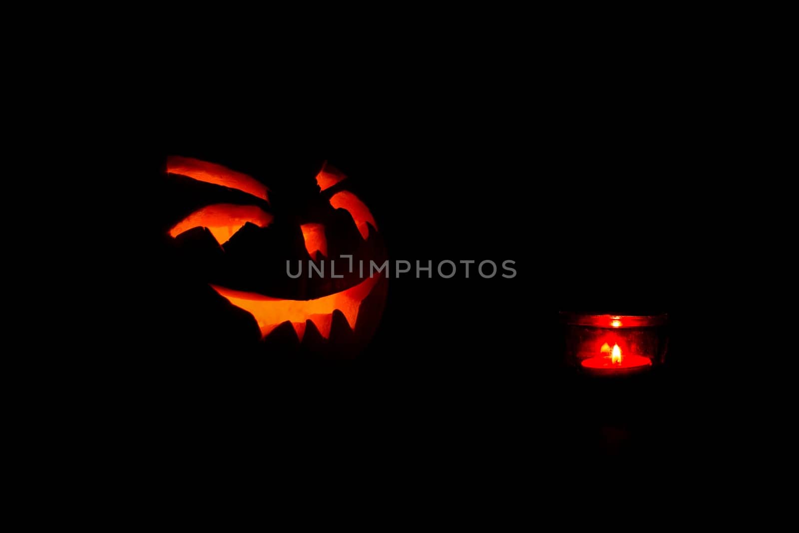 halloween pumpkins with candle on black background