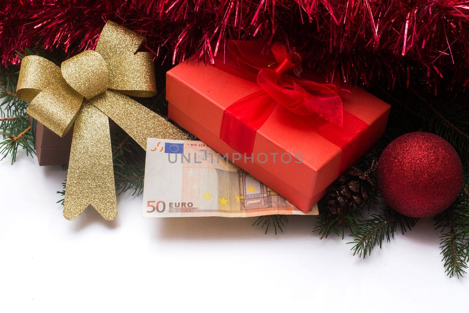 christmas gift box with euro money on white background