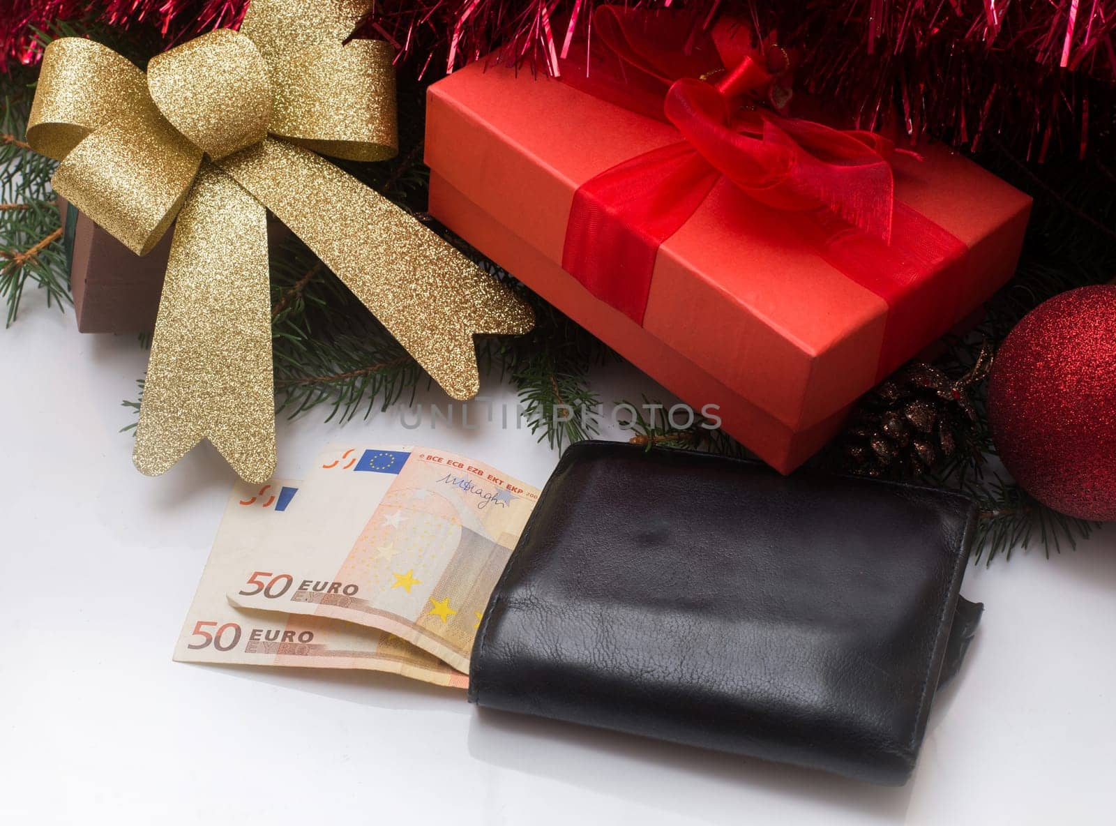 christmas gift box and wallet with euro money on white background