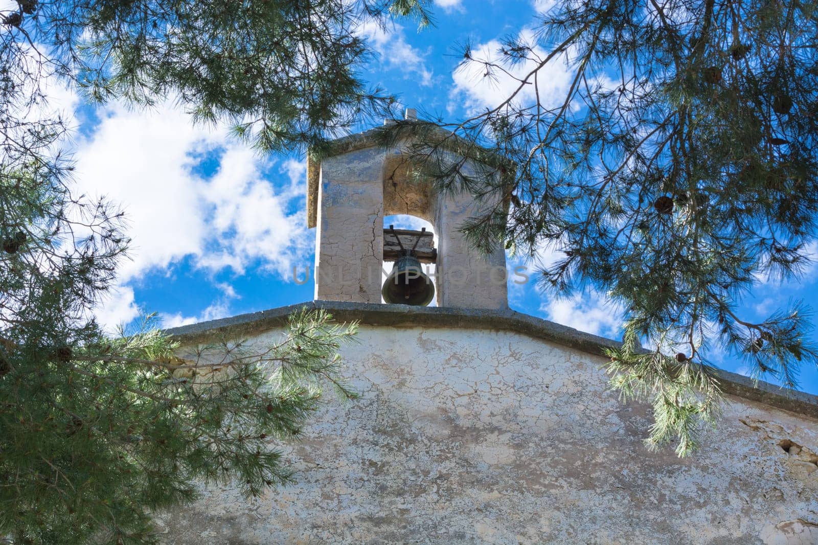 Bell in Spanish style against a blue sky..