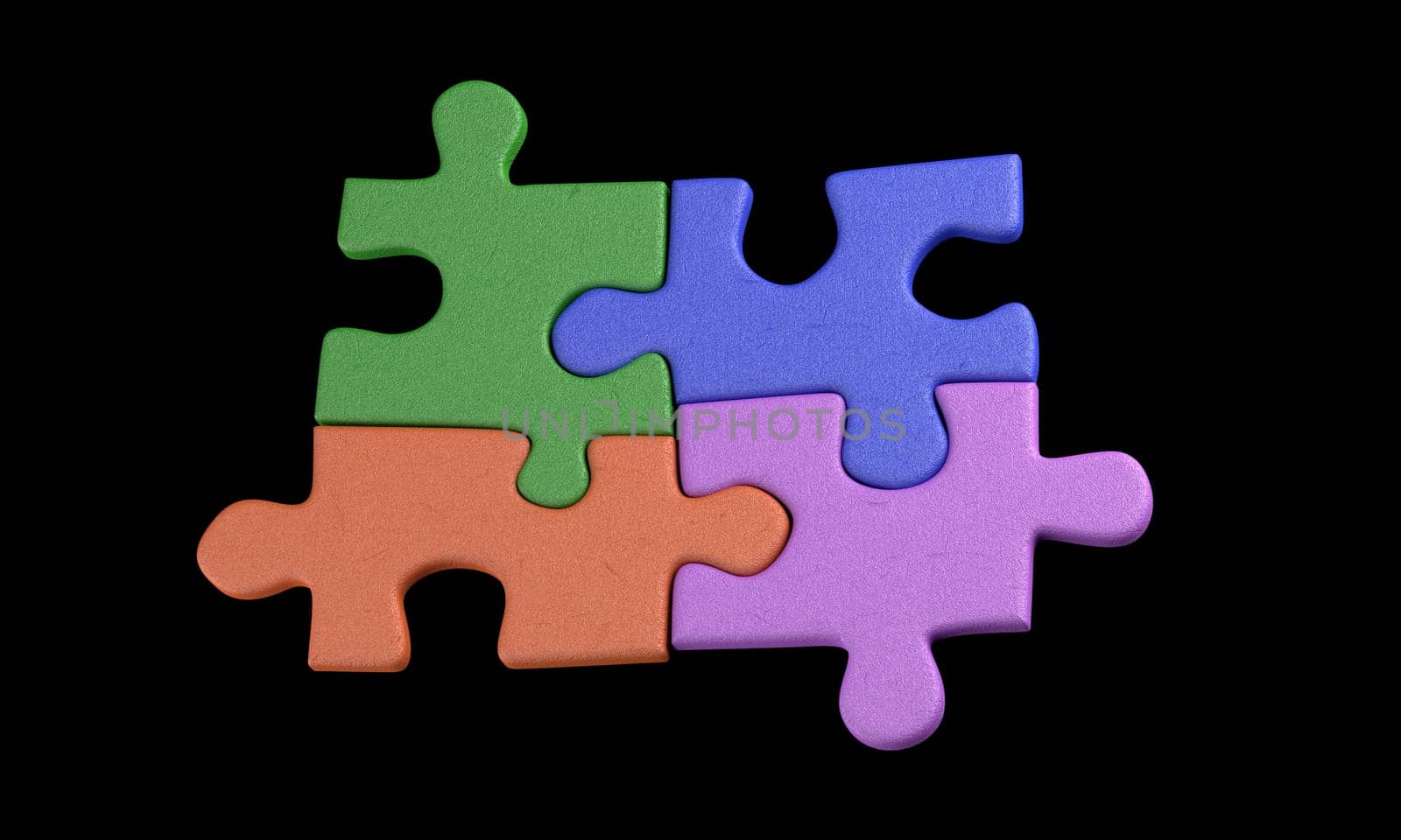 four colorful puzzle pieces on black