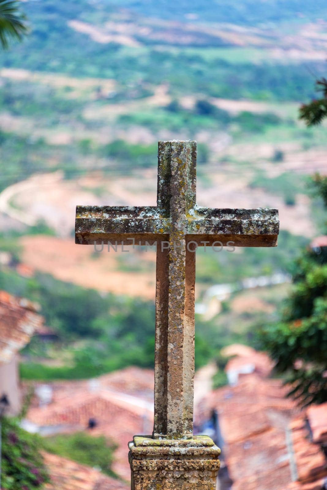View of a stone cross outside of the Santa Barbara church in Barichara, Colombia