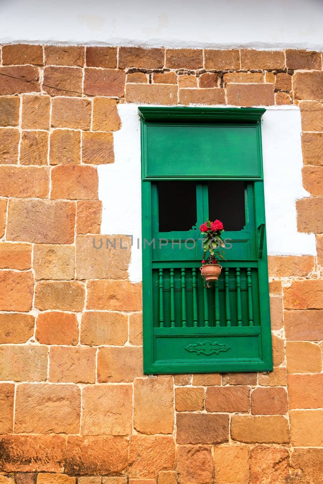 Green colonial window in the historic town of Barichara, Colombia