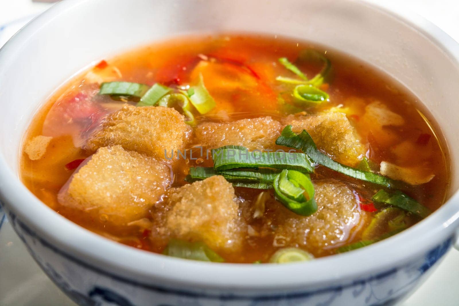Bowl on a table with a traditional Chinese soup.
