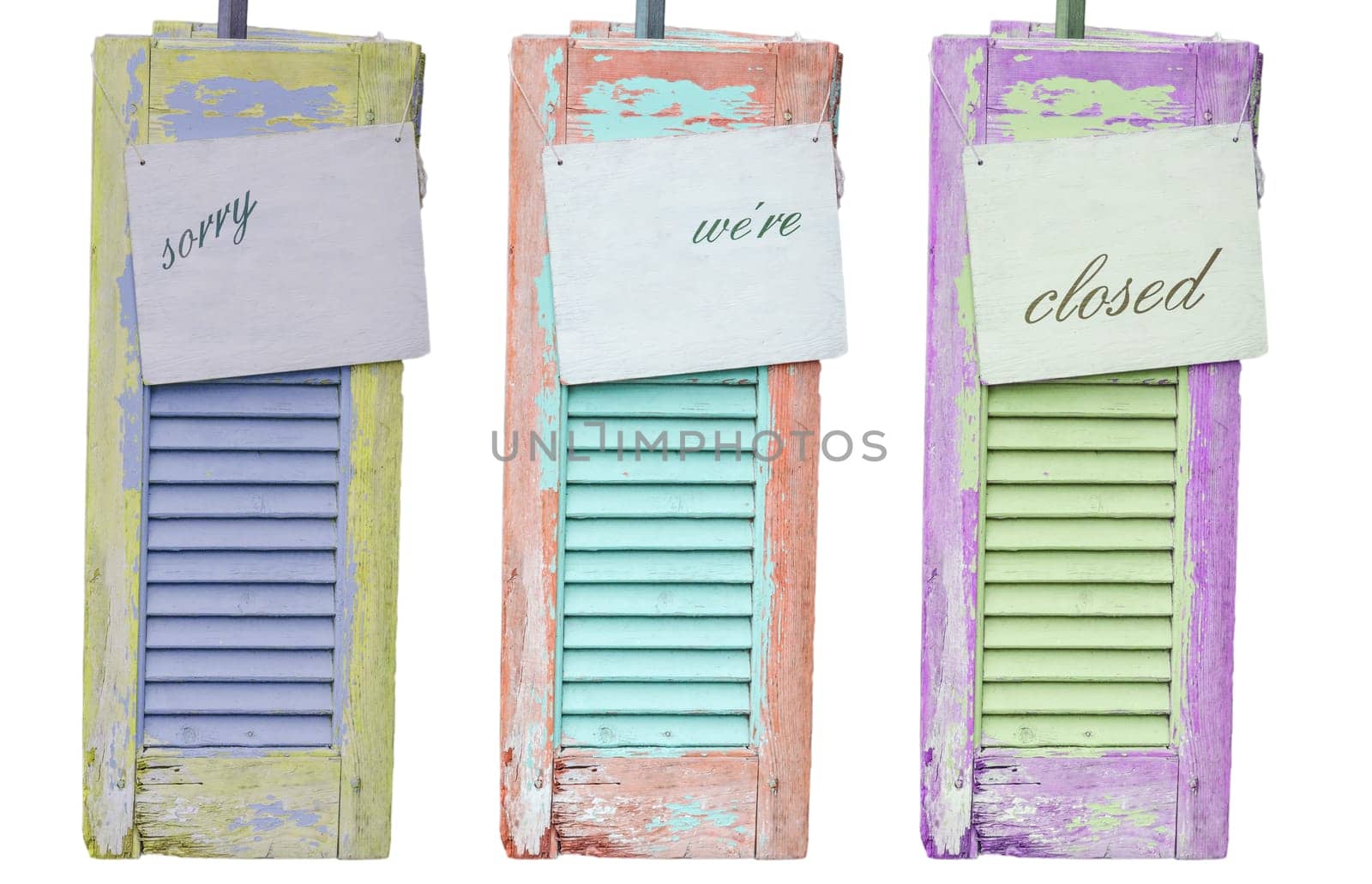 Three old decorative weathered wooden shutters with the inscription Sorry were Closed.