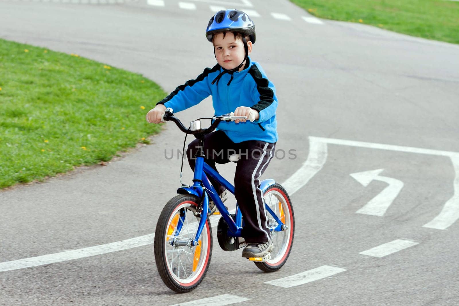 child on a bicycle at asphalt road on traffic playground