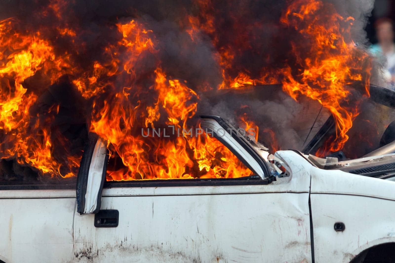 burning and then extinguish an old white car - Exercise firefighters