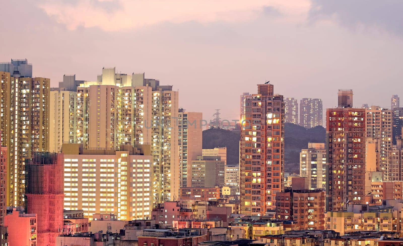 urban city at sunset with all lights lit up