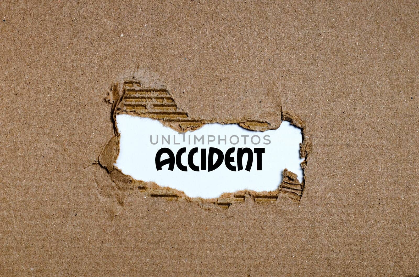 The word accident appearing behind torn paper