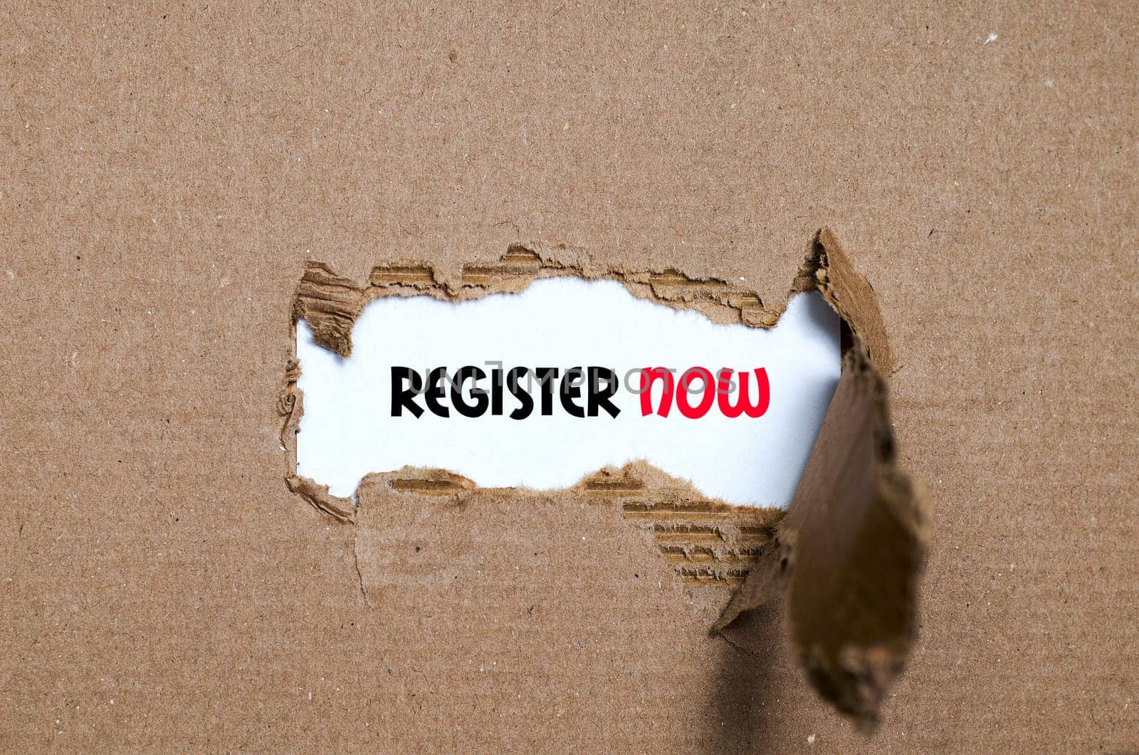 The word register now appearing behind torn paper
