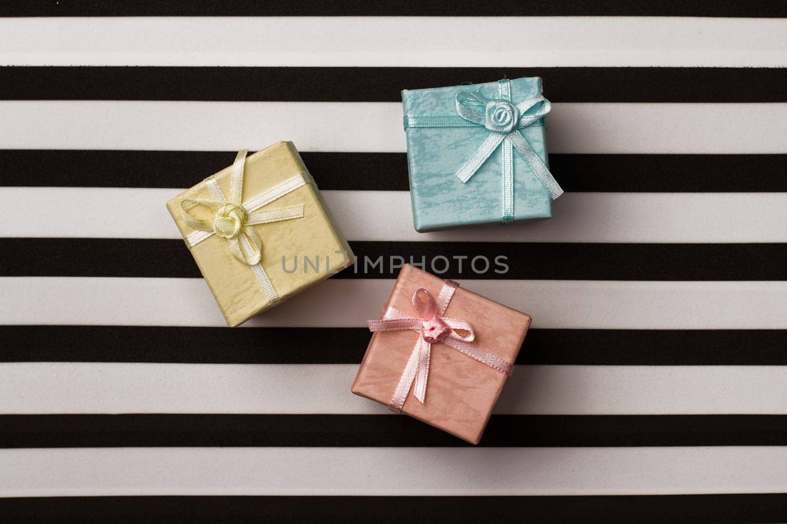 top view of colored gift boxes on black and white stripes background