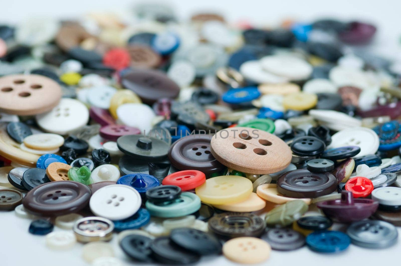 Close-up of many different colorful buttons in a pile.
