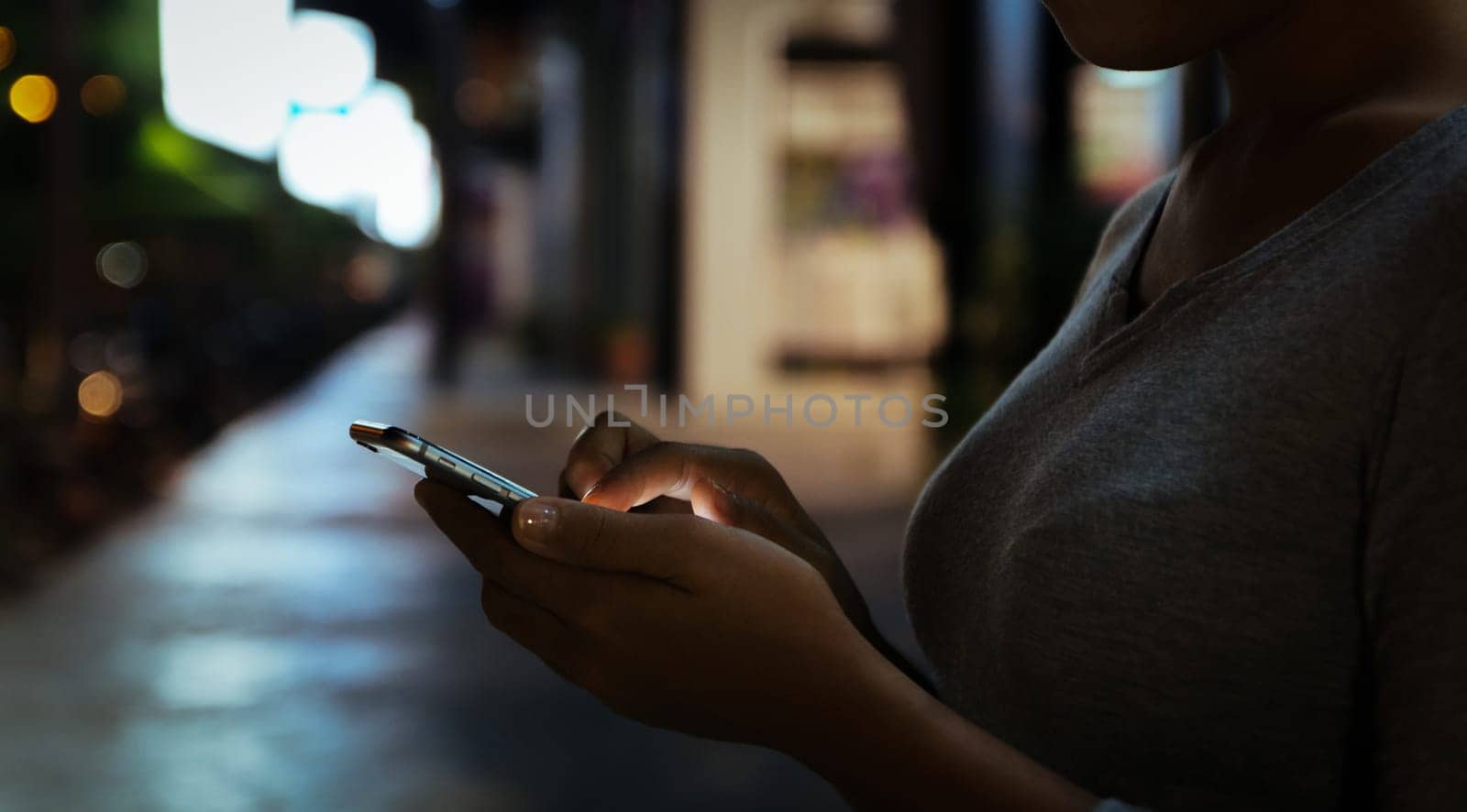 close up woman use phone on night in city