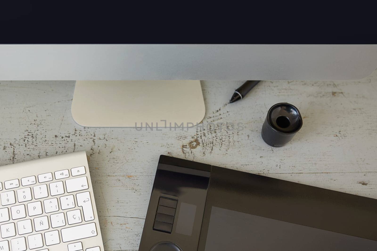 Top View of Computer, Keyboard and Graphic Tablet on Wooden Table.