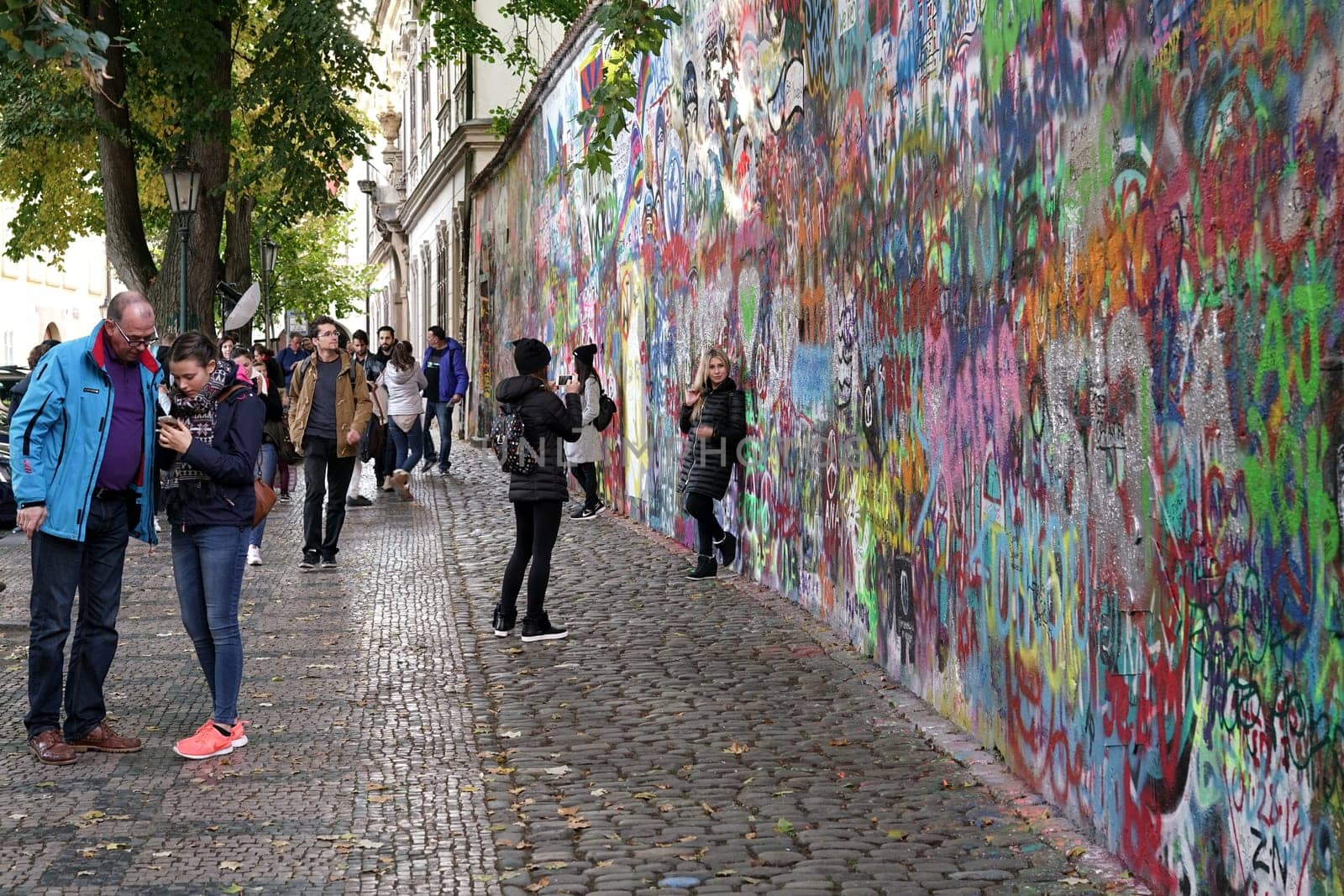 Tourists at the John Lennon Wall in the Old Town of Prague