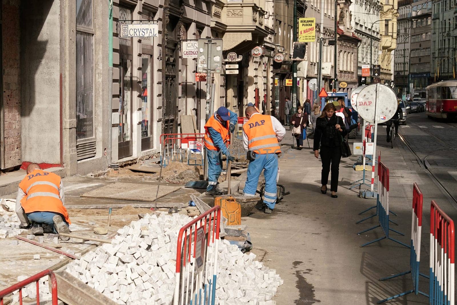 Construction workers renew a cobblestone footpath in downtown Prague