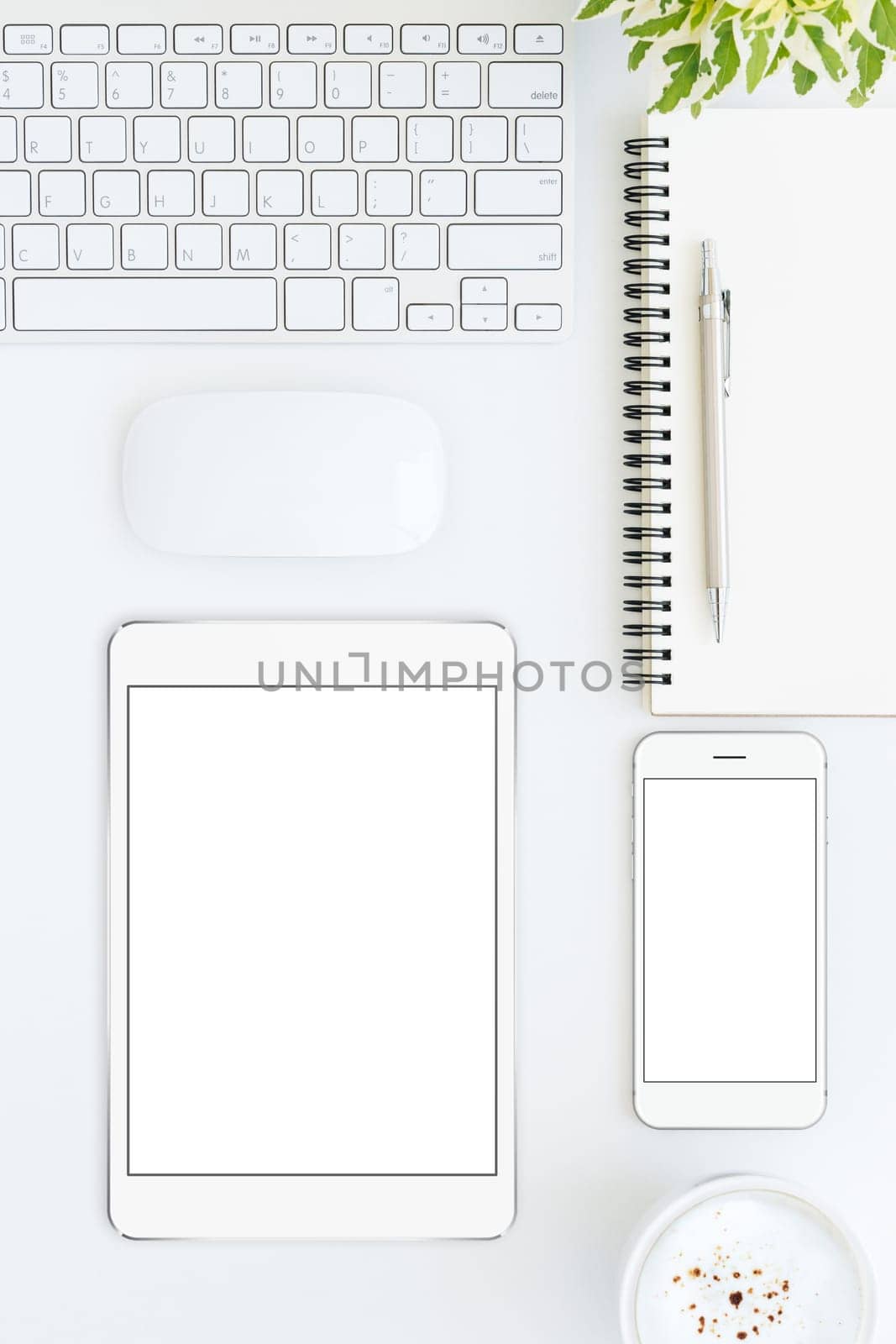 phone and tablet blank screen on white table format vertical top view