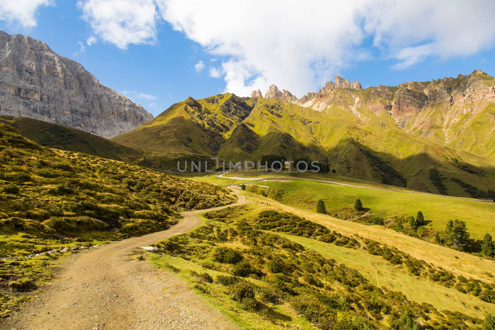 View of a hiking trail on Seiser Alm with mountain range on the background