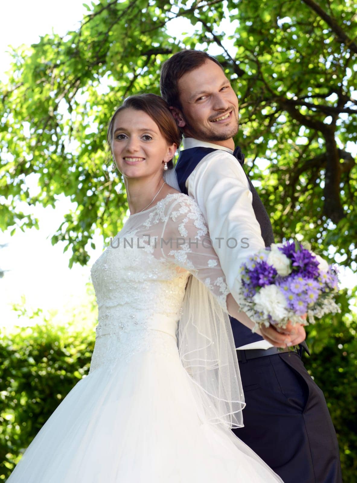 Happy bridal couple with bridal bouquet