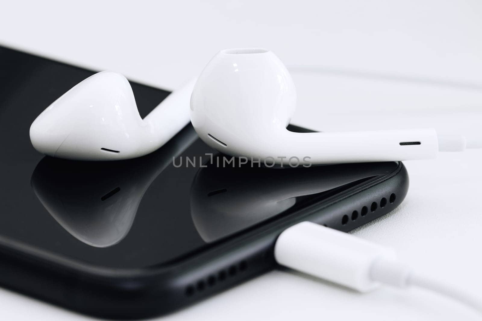 close-up phone and headphone on table
