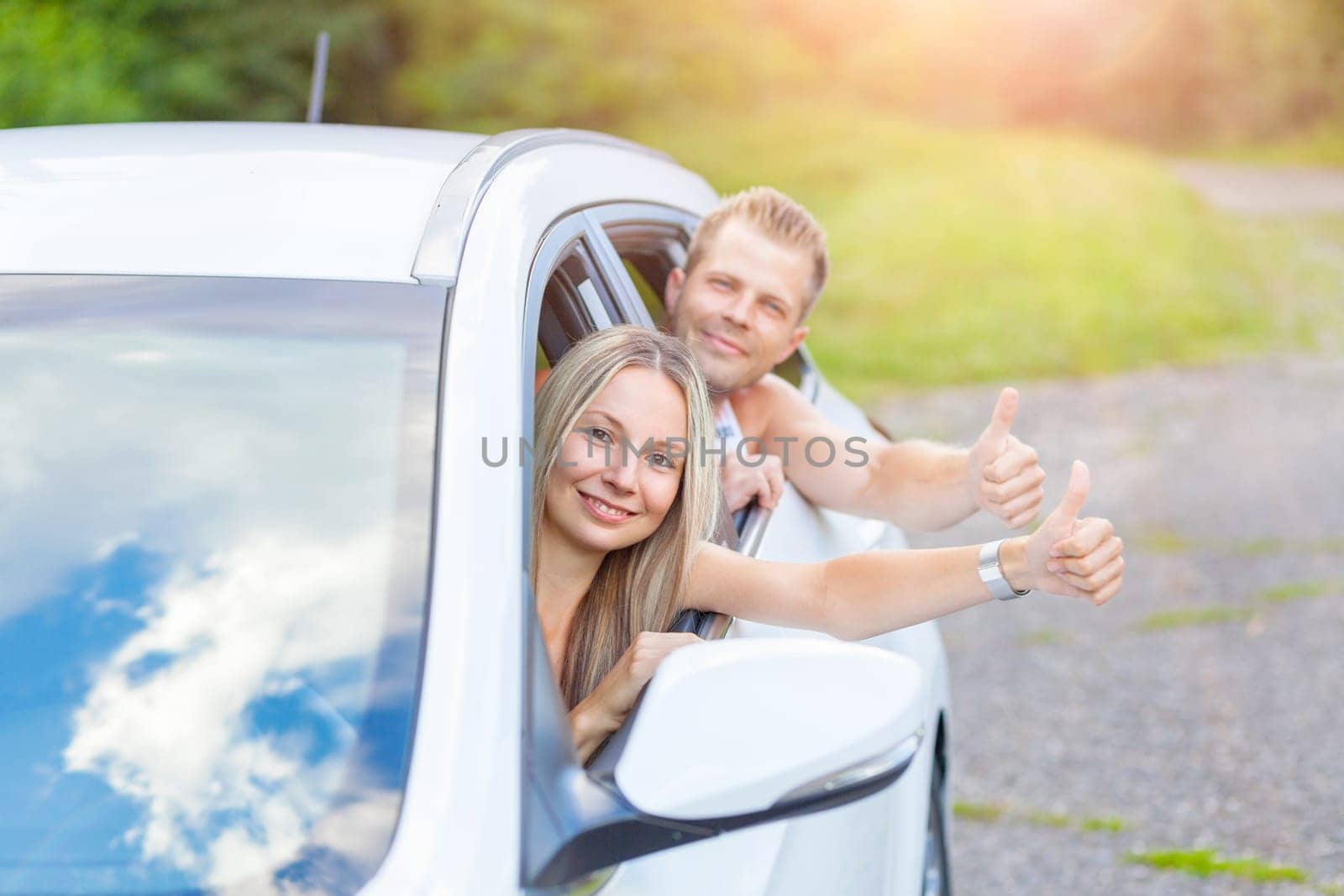 Young happy people enjoying a roadtrip in the car