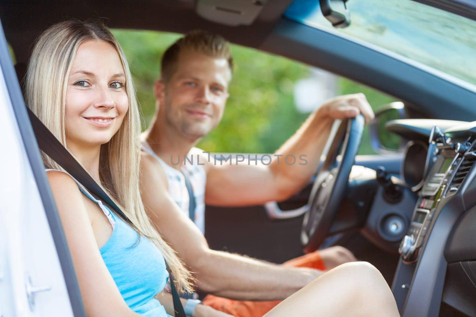 Young happy people enjoying a roadtrip in the car
