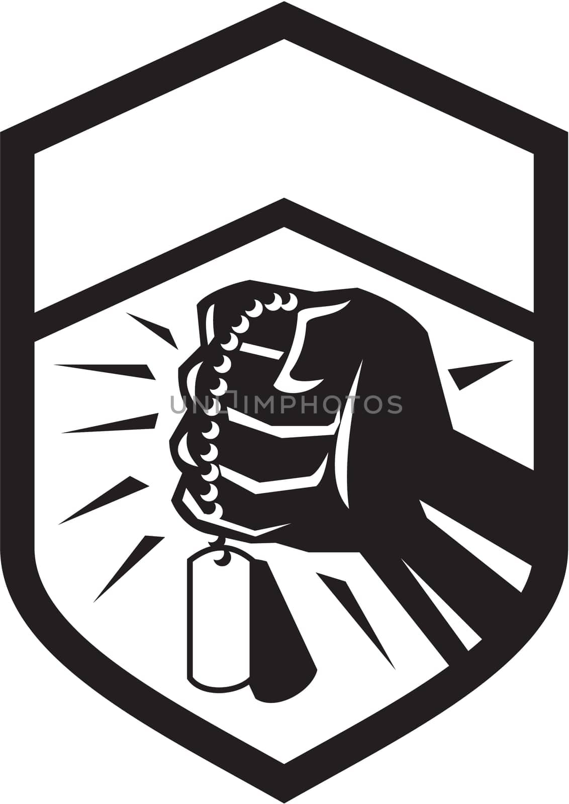 Illustration of a clenched fist clutching holding dogtag set inside shield crest done in black and white retro style.